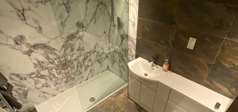 Nuance panels in Carrara Marble fitted by Rothwell Tiles and Bathrooms 
